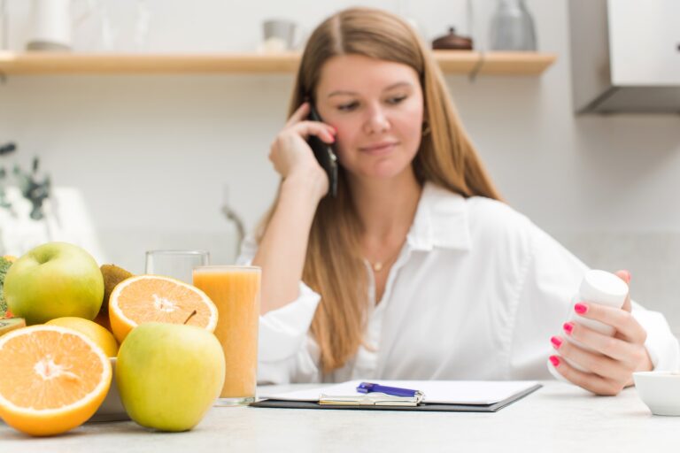 A nutritionist advises a client by phone on a nutrition plan and vitamin intake